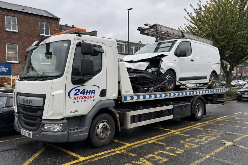 White DAF recovery truck providing professional accident recovery services for a damaged van
