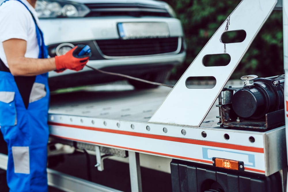 The process of a car towing hookup being executed by a trained service professional