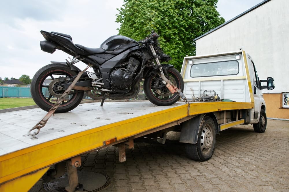 Emergency motorcycle breakdown recovery in Birmingham featuring secured sportbike on transport trailer