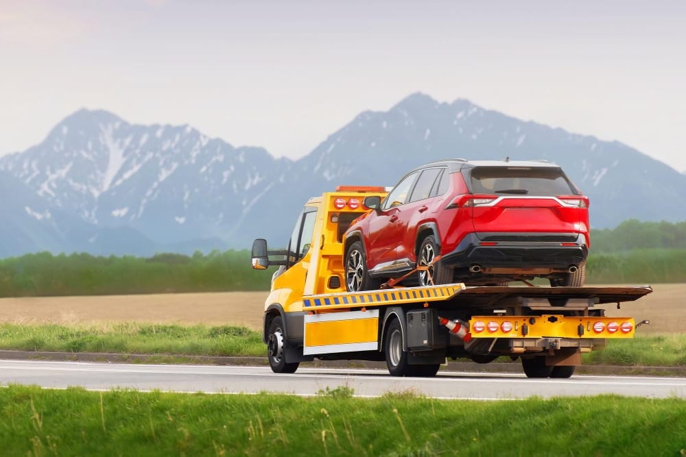 Reliable roadside assistance services in Barmingham towing a red vehicle safely