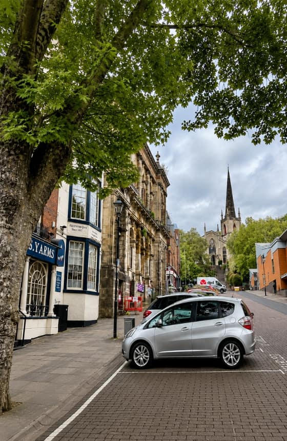 A silver car parks on a street near breakdown recovery Walsall town centre
