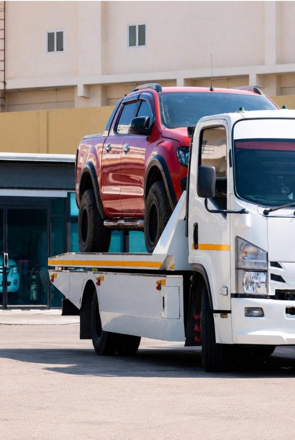 Flatbed truck transports red pickup showing west bromwich drivers choose birmingham recovery 247