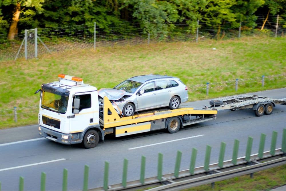 Flatbed tow truck manages roadside breakdown recovery in Dudley on highway
