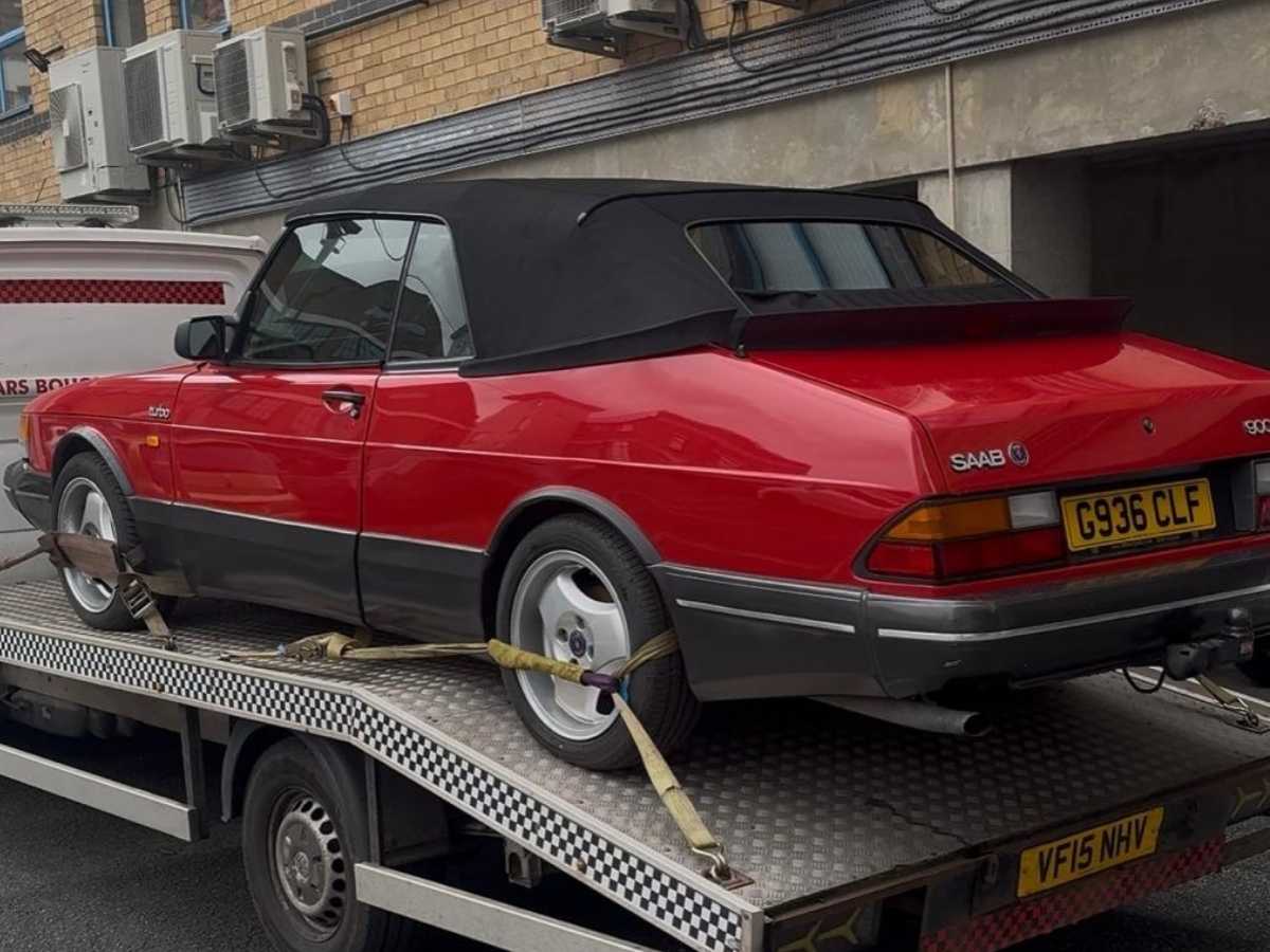 Red convertible Saab loaded on tow truck for car breakdown recovery Selly Oak