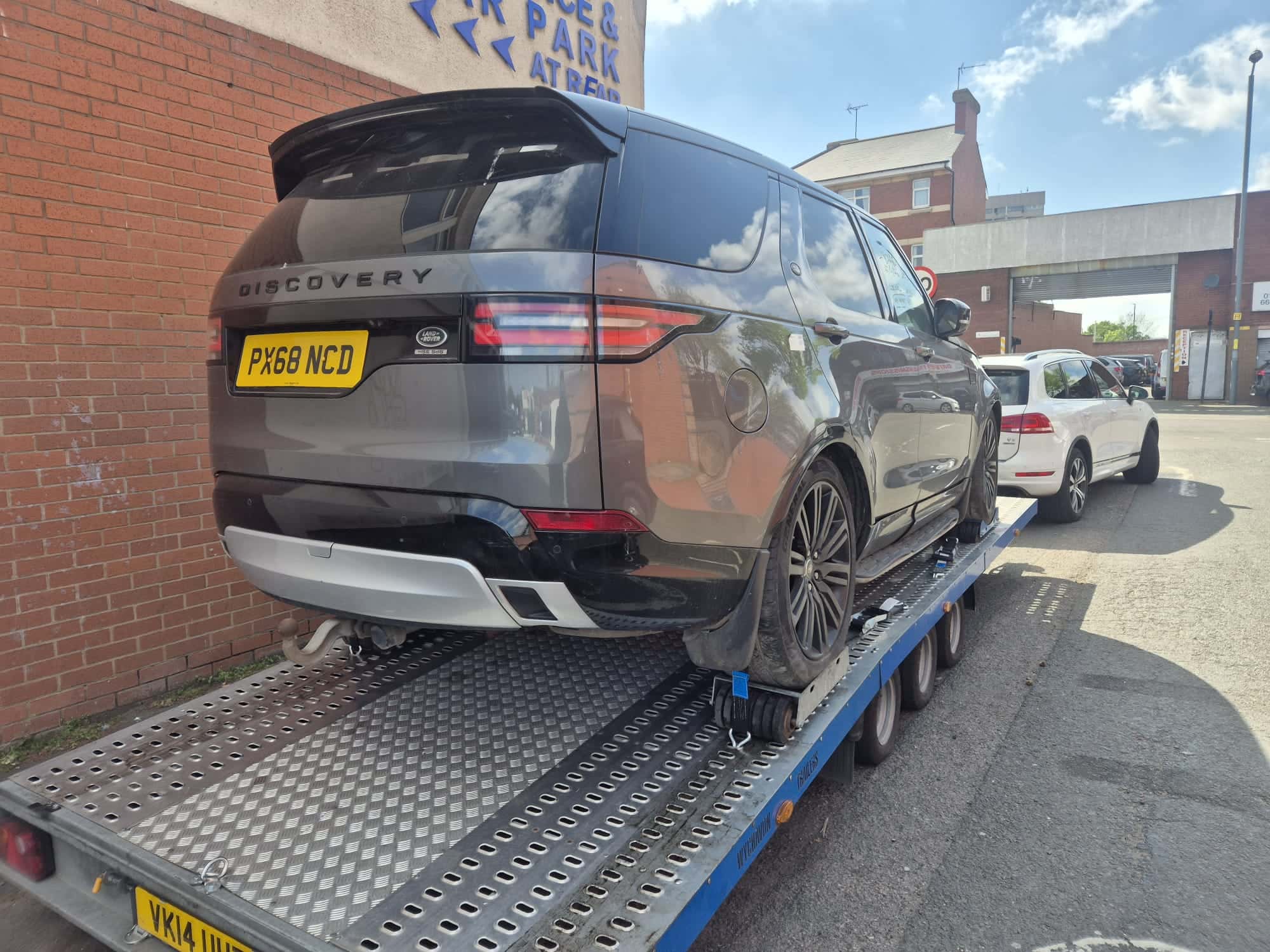 Land Rover Discovery secured on a flatbed recovery trailer