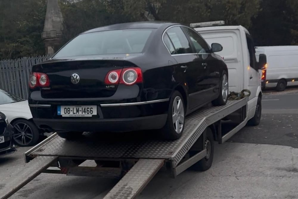 Black Volkswagen sedan loaded onto truck for breakdown recovery Edgbaston services